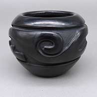 Small black jar with a carved geometric design
 by Stella Chavarria of Santa Clara