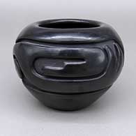 Black jar with a carved geometric design
 by Stella Chavarria of Santa Clara