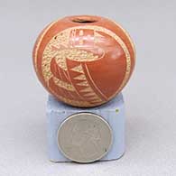 Miniature red jar with a sgraffito three-panel male yeibichai design
 by Mae Tapia of Santa Clara
