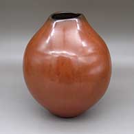 Polished red jar with an organic opening and fire clouds
 by Jody Folwell of Santa Clara