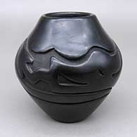 Black jar with a carved avanyu design
 by Stella Chavarria of Santa Clara