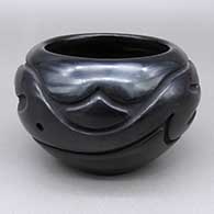 Black bowl with a carved raincloud and geometric design
 by Stella Chavarria of Santa Clara