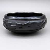 Black bowl with a carved avanyu design
 by Dolorita Padilla of Santa Clara
