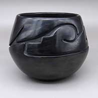Black bowl with a carved stylized avanyu design
 by Sharon Naranjo Garcia of Santa Clara