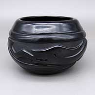 Black bowl with a carved avanyu and geometric design
 by Clara Shije of Santa Clara