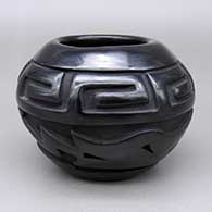 Black jar with a carved avanyu and geometric design
 by Jennifer Naranjo of Santa Clara