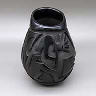 Black jar with an asymmetrical opening and a carved kokopelli and geometric design
 by Rosemary Lewis of Santa Clara