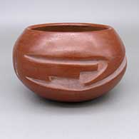Red bowl with a carved geometric design
 by Juanita Gonzales of San Ildefonso
