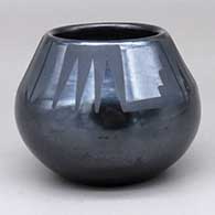 A small black-on-black jar with a two-panel geometric design above the shoulder
 by Maria Martinez of San Ildefonso