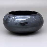A black-on-black bowl with a four-panel geometric design
 by Maria Martinez of San Ildefonso