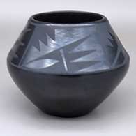 A black-on-black bowl with a four-panel geometric design above the shoulder
 by Maria Martinez of San Ildefonso