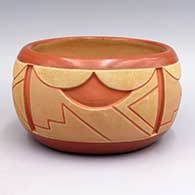 Red and tan jar with carved geometric design
 by Rosita de Herrera of Ohkay Owingeh