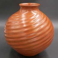 Red jar with pushed spiral melon ribs
 by Samuel Quezada of Mata Ortiz and Casas Grandes