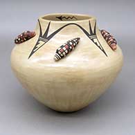 Polychrome jar with an applique and painted ear-of-corn and geometric design on outside and a painted lightning bolt detail inside opening
 by Juanita Fragua of Jemez