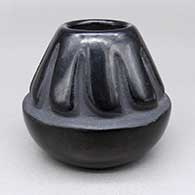 Small black jar with a carved feather ring geometric design
 by Helen Shupla of Santa Clara