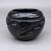 Black bowl with a carved geometric design
 by Jennie Trammel of Santa Clara