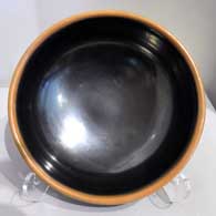 Black bowl with a sienna rim 
 by Maria Martinez of San Ildefonso