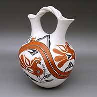 Polychrome wedding vase with a braided handle and a painted traditional Acoma design featuring parrot, flower, rainbow, fine line, and geometric elements
 by Marie Z Chino of Acoma
