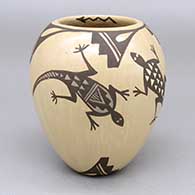 Polychrome jar with a lizard, kiva step, and geometric design around the outside and a lightning bolt detail inside the rim
 by Juanita Fragua of Jemez