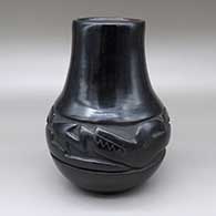 Black-on-black jar with a carved and painted avanyu design
 by LuAnn Tafoya of Santa Clara