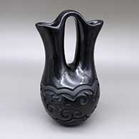 Black wedding vase with micaceous slip details and a carved avanyu design
 by Linda Tafoya of Santa Clara