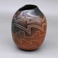 Sienna jar with black spots, an organic opening, and a sgraffito geometric design
 by Polly Rose Folwell of Santa Clara