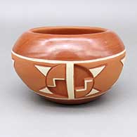 Polychrome Potsuwii bowl with a carved and painted four-panel geometric design
 by Rosita de Herrera of Ohkay Owingeh