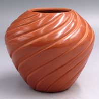 Red jar carved with a spiral melon design with 12 ribs
 by Pauline Romero of Jemez