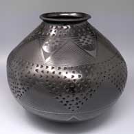 Black-on-black jar with a rolled lip, notched rim and bands of fine line and geometric design with bands of corrugation
 by Consolacion Quezada of Mata Ortiz and Casas Grandes
