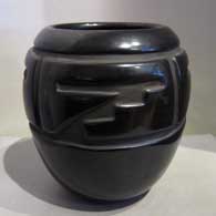 Black jar carved with four panel geometric design 
 by Margaret Tafoya of Santa Clara