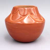 Polished red jar with kiva and raincloud carvings above shoulder
 by Rose Gonzales of San Ildefonso