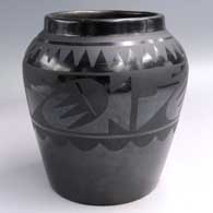 Black-on-black jar with a raised rim and a 4-panel geometric design
 by Maria Martinez of San Ildefonso