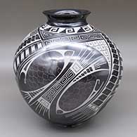Gunmetal and white jar with a flared opening and a sgraffito and painted fish and geometric design
 by Cesar Bugarini of Mata Ortiz and Casas Grandes