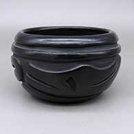 Black bowl with a carved avanyu design
 by Billy Cain of Santa Clara