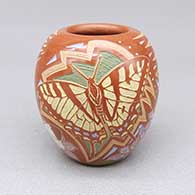 Small polychrome jar with micaceous slip details and a sgraffito and intricately painted butterfly, flower, and geometric design
 by Jennifer Moquino of Santa Clara