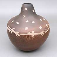 Sienna jar with an organic opening, fire clouds, and a sgraffito lizard and geometric design
 by Bernice Naranjo of Taos