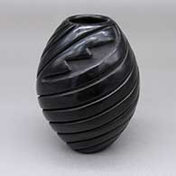 Small black jar with a carved spiral melon and geometric design
 by Denise Chavarria of Santa Clara