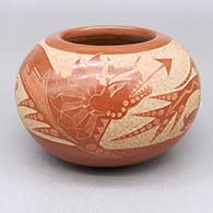 Red jar with a sgraffito avanyu, quail, kokopelli, lizard, and rabbit design
 by Corn Moquino of Santa Clara