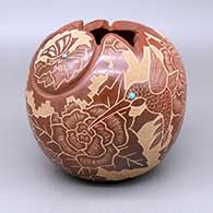 Red jar with a geometric cut opening, a carved and sgraffito hummingbird, butterfly, flower, and kiva step geometric design, and inlaid turquoise and stone details
 by Gwen Tafoya of Santa Clara