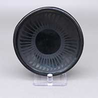 Small black-on-black plate with a feather ring geometric design
 by Blue Corn of San Ildefonso