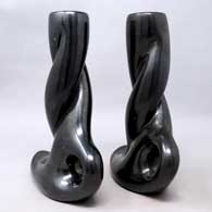 Apairofcarved,twistedblackcandlestickholders, click or tap to see a larger version