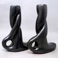 Apairofcarved,twistedblackcandlestickholders, click or tap to see a larger version