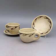 Four piece black and white teacup and saucer set, with geometric design
 by Fawn Navasie of Hopi