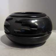 Black jar carved with stylized avanyu design
 by Teresita Naranjo of Santa Clara