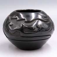 Black jar carved with an avanyu and geometric design
 by Stella Chavarria of Santa Clara