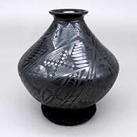 Black-on-black jar with a flared opening and geometric design
 by Salvador Baca of Mata Ortiz and Casas Grandes