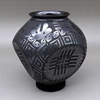 Black-on-black jar with a slightly flared opening, a distinctive indented body, and a painted geometric design
 by Eduardo Ortiz aka Chevo of Mata Ortiz and Casas Grandes