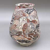 Polychrome jar with a flared opening and an interlocking fish geometric design
 by Manuel Rodriguez Guillen of Mata Ortiz and Casas Grandes