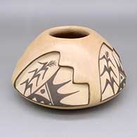 Buff and black jar with a four-panel carved and painted cornstalk, kiva step, and geometric design
 by Juanita Fragua of Jemez