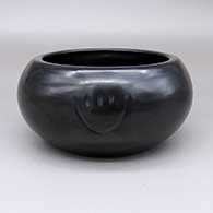 Black bowl with two imprinted bear paw designs
 by Sherry Tafoya of Santa Clara